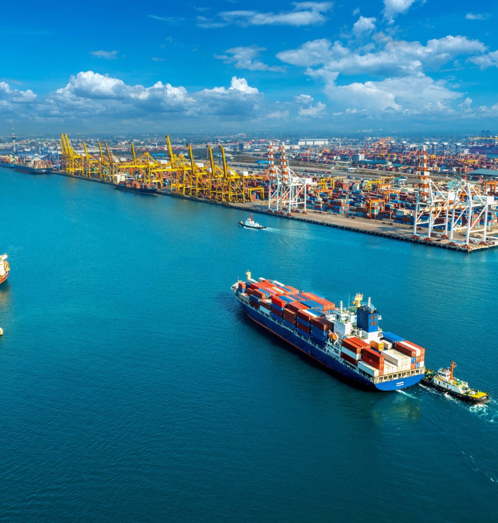 Aerial view of cargo ship and cargo container in harbor.